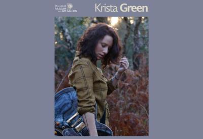 Young lady (Krista Green) standing in woodland with guitar