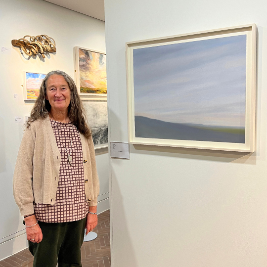 Artist Sara Lee standing in front of winning artwork, 'Restore'.