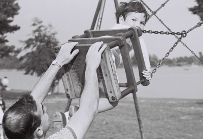 Image of a family playing on the swings at The Heath in Petersfield
