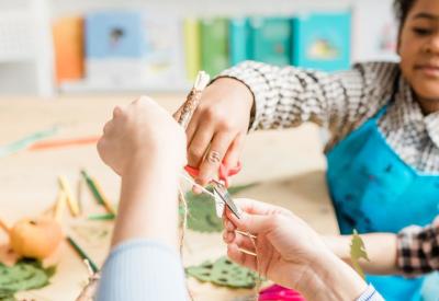 two children taking part in a craft activitiy.