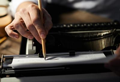 Writer editing their work from a typewriter