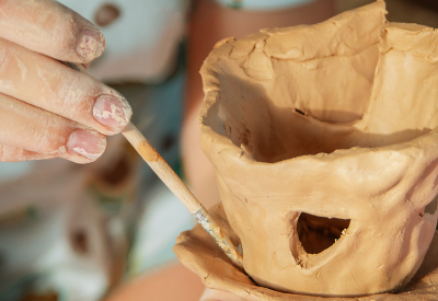 Child building clay house