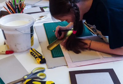 Child bookbinding in a workshop