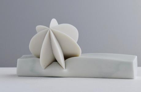 White porcelain artwork sitting on white counter with grey background