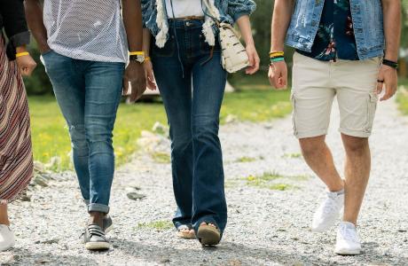 Walking group of 5 individuals from the waist down.