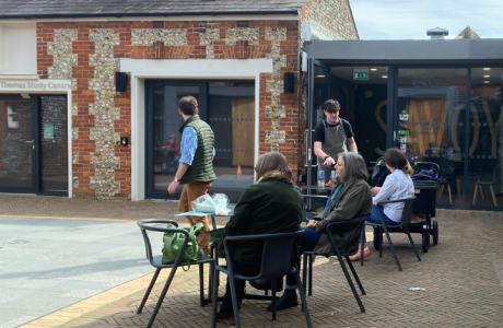 Visitors enjoying the sunny courtyard at Petersfield Museum and Art Gallery