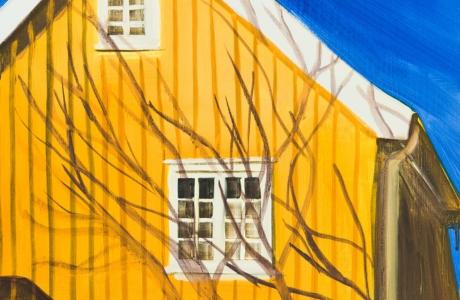 Bright yellow house with shadows of a tree.