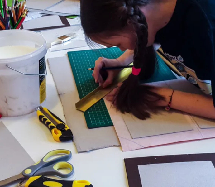 Child bookbinding in a workshop