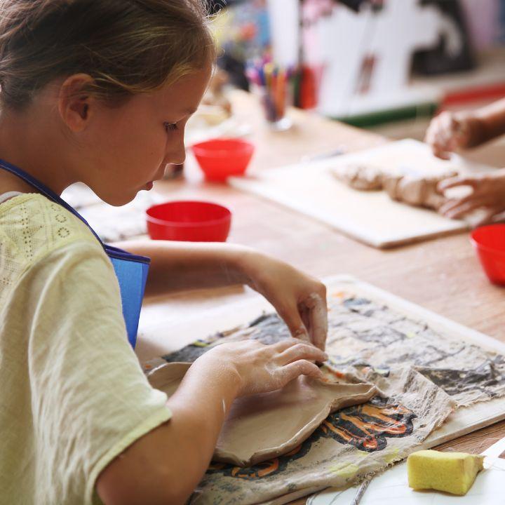 Child working in clay pot
