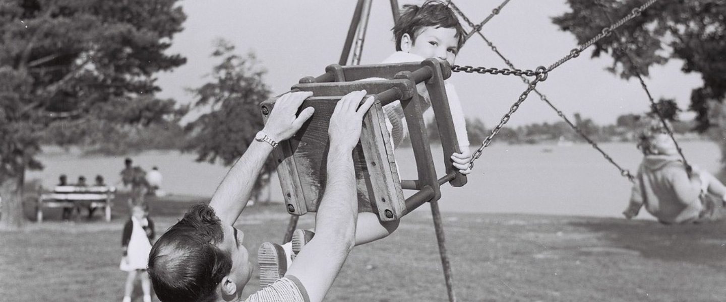 Image of a family playing on the swings at The Heath in Petersfield