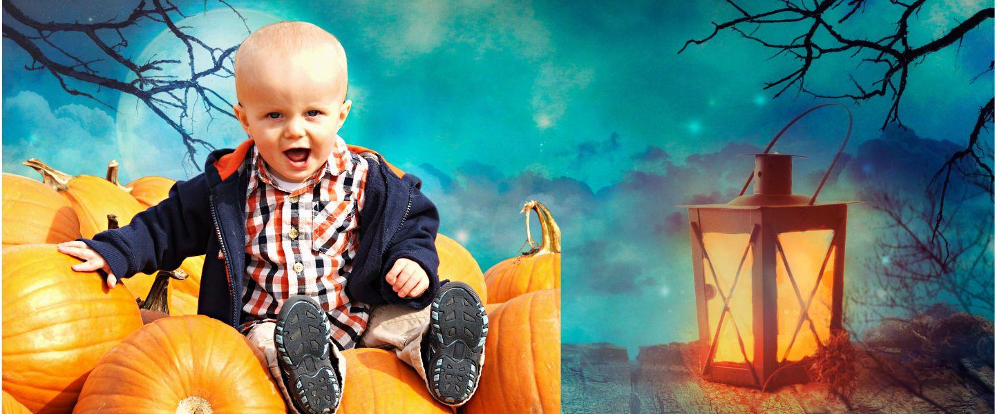 Toddler sat on pumpkins with creepy background