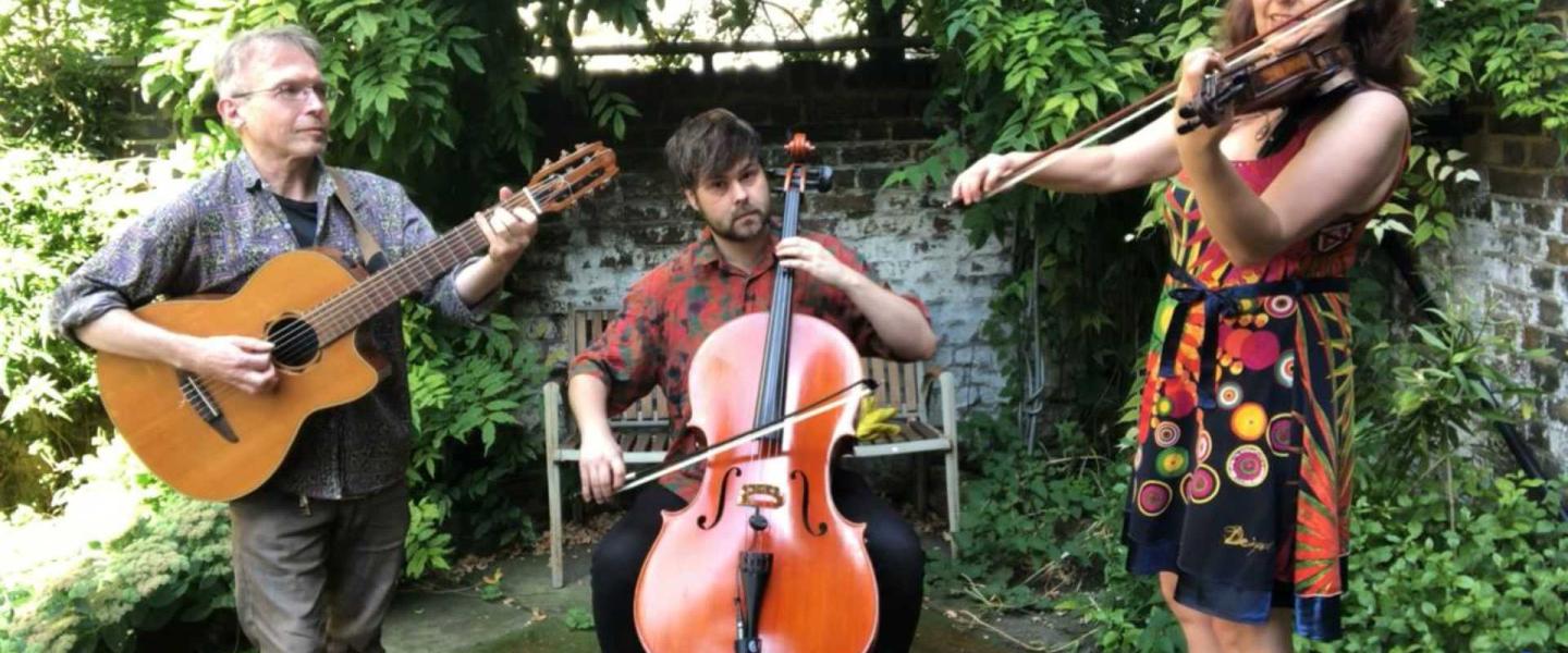 Three musicians, 1 guitar, 1 cello and 1 violin