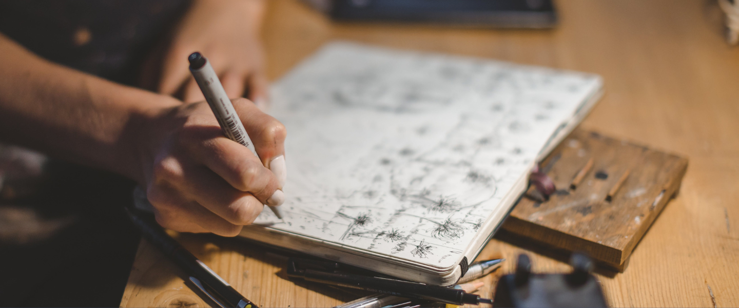 Artist sketching in journal.