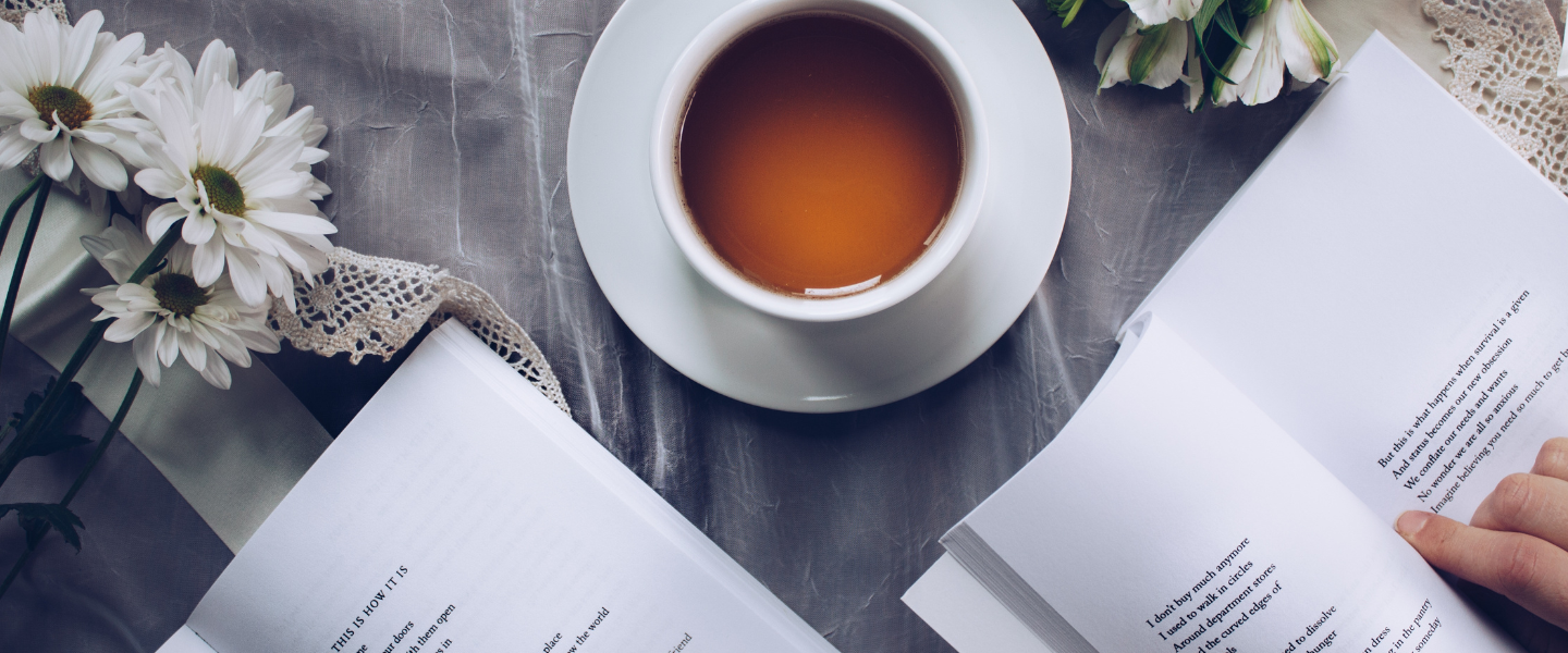 Table with poetry books, tea and flowers