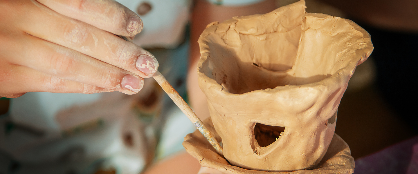 Child building clay house