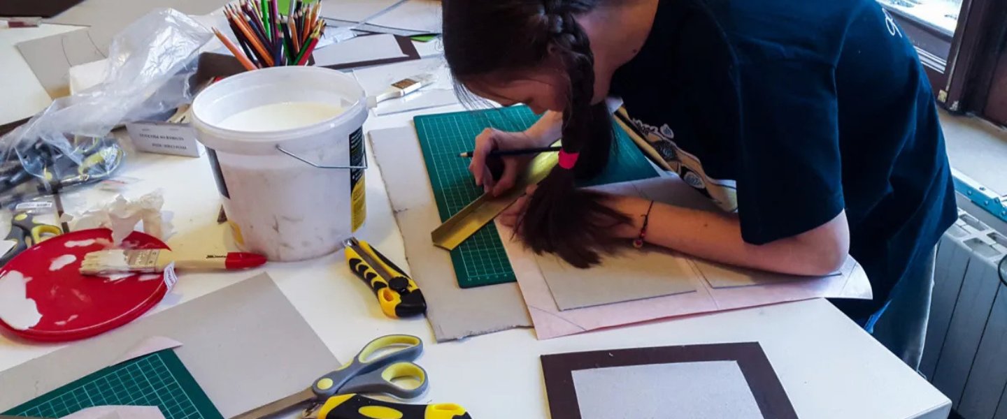 Child bookbinding in a workshop