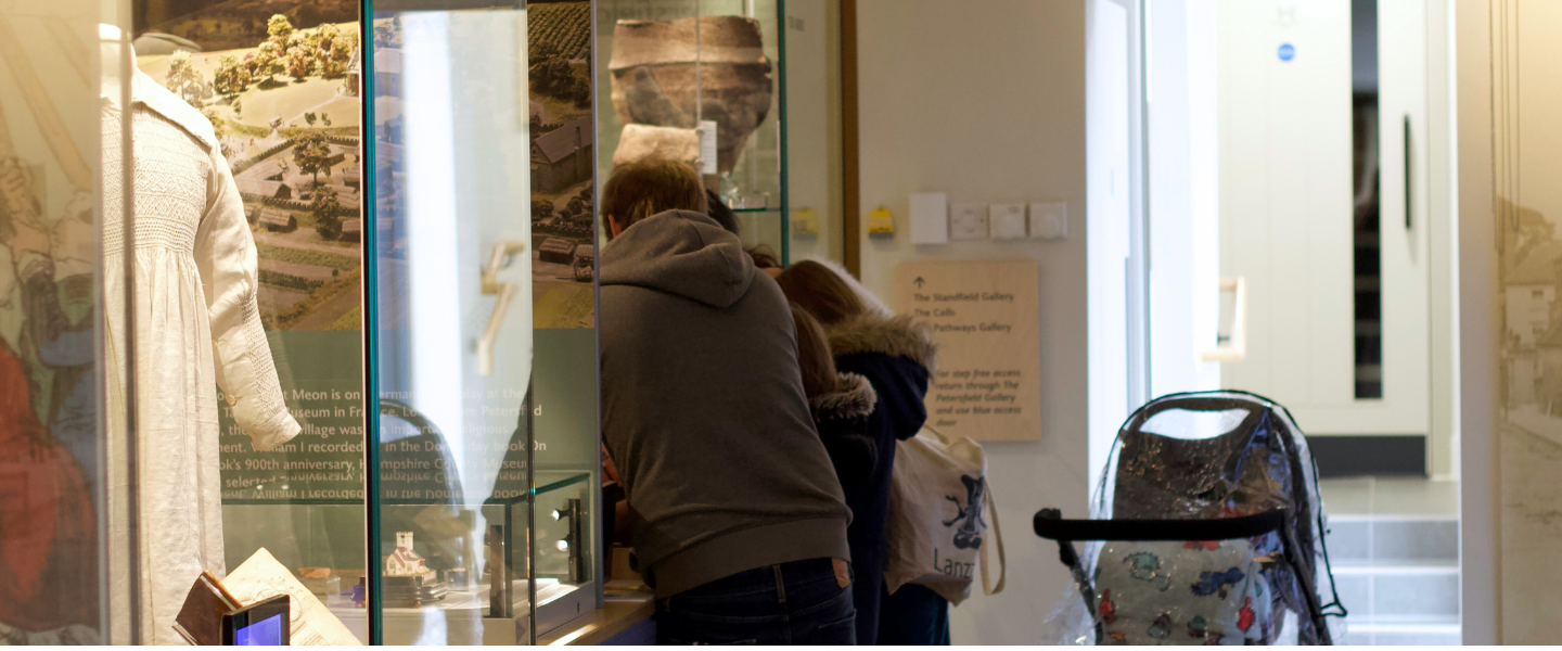 Family looking at the archaeology collection items on display