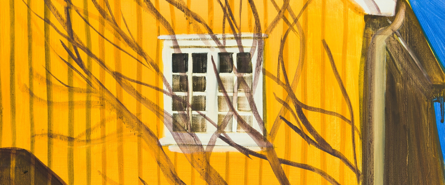 Bright yellow house with shadows of a tree.