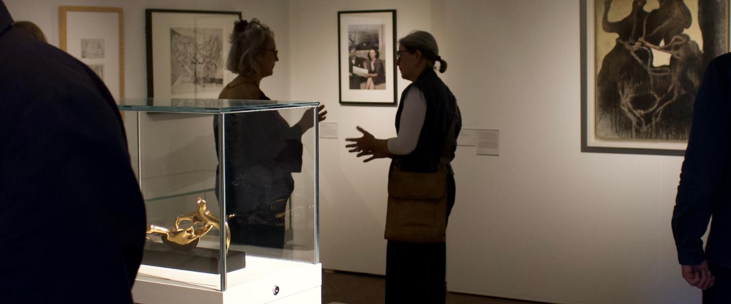 Visitors in the Flora Twort Gallery with Henry Moore and Max Ernst artworks on display.